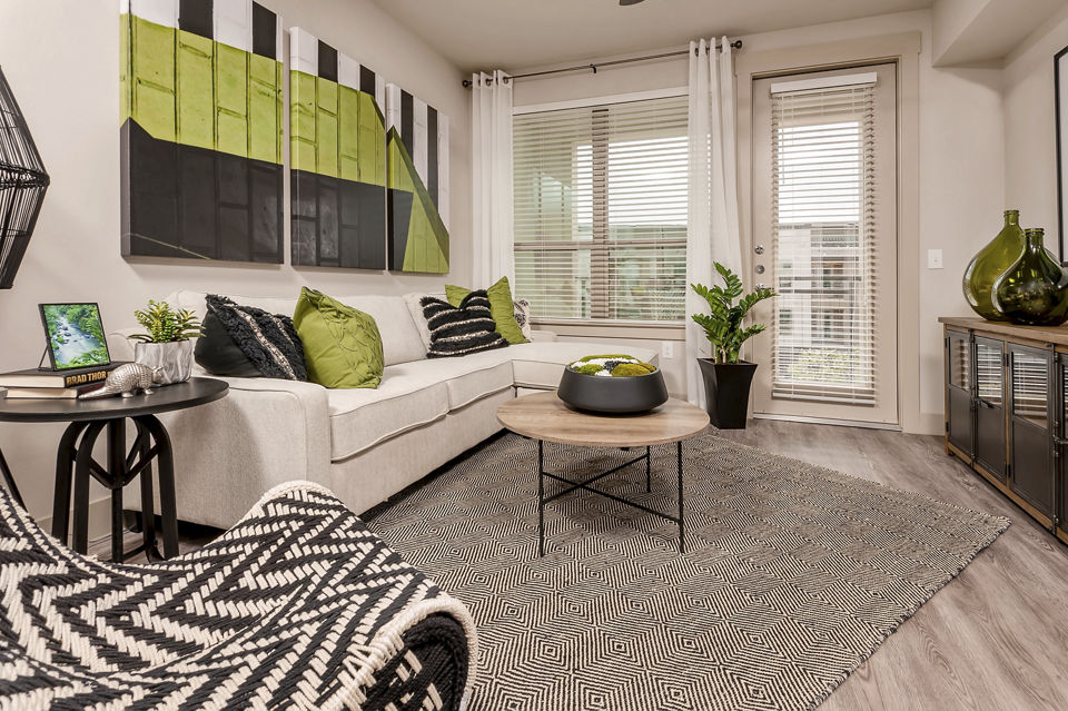 Spacious living room with modern decor in The Kelley at Samuels Avenue Apartments