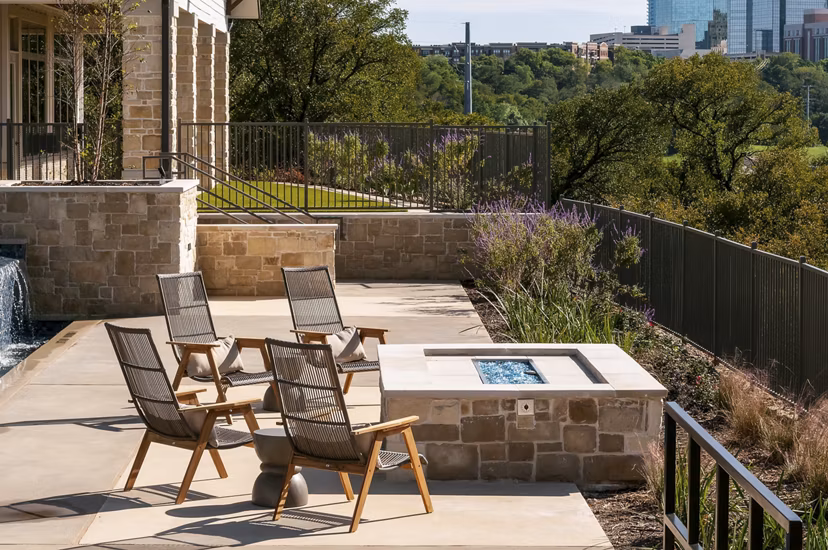 Fire pit with cozy seating area at The Kelley at Samuels Avenue Apartments, highlighting outdoor relaxation space