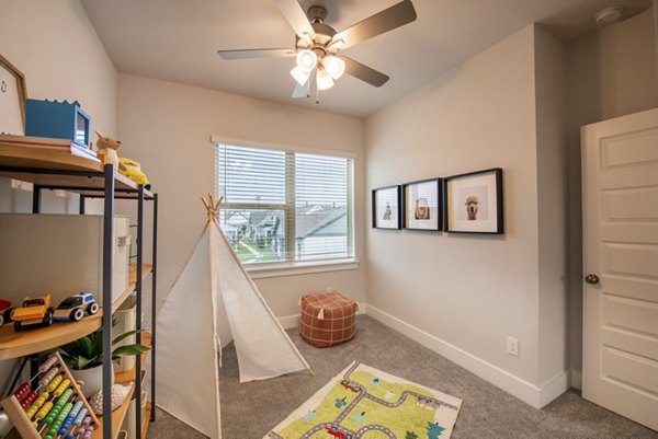 Cozy bedroom featuring modern decor at Mission at Johnson Creek Apartments with plush bedding and ample natural light