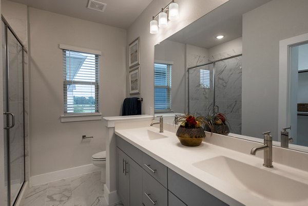 Contemporary bathroom with elegant fixtures at Mission at Johnson Creek Apartments