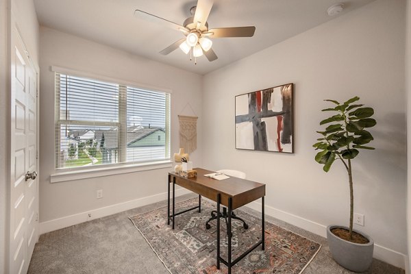 Home office with ergonomic desk and chair in Mission at Johnson Creek Apartments