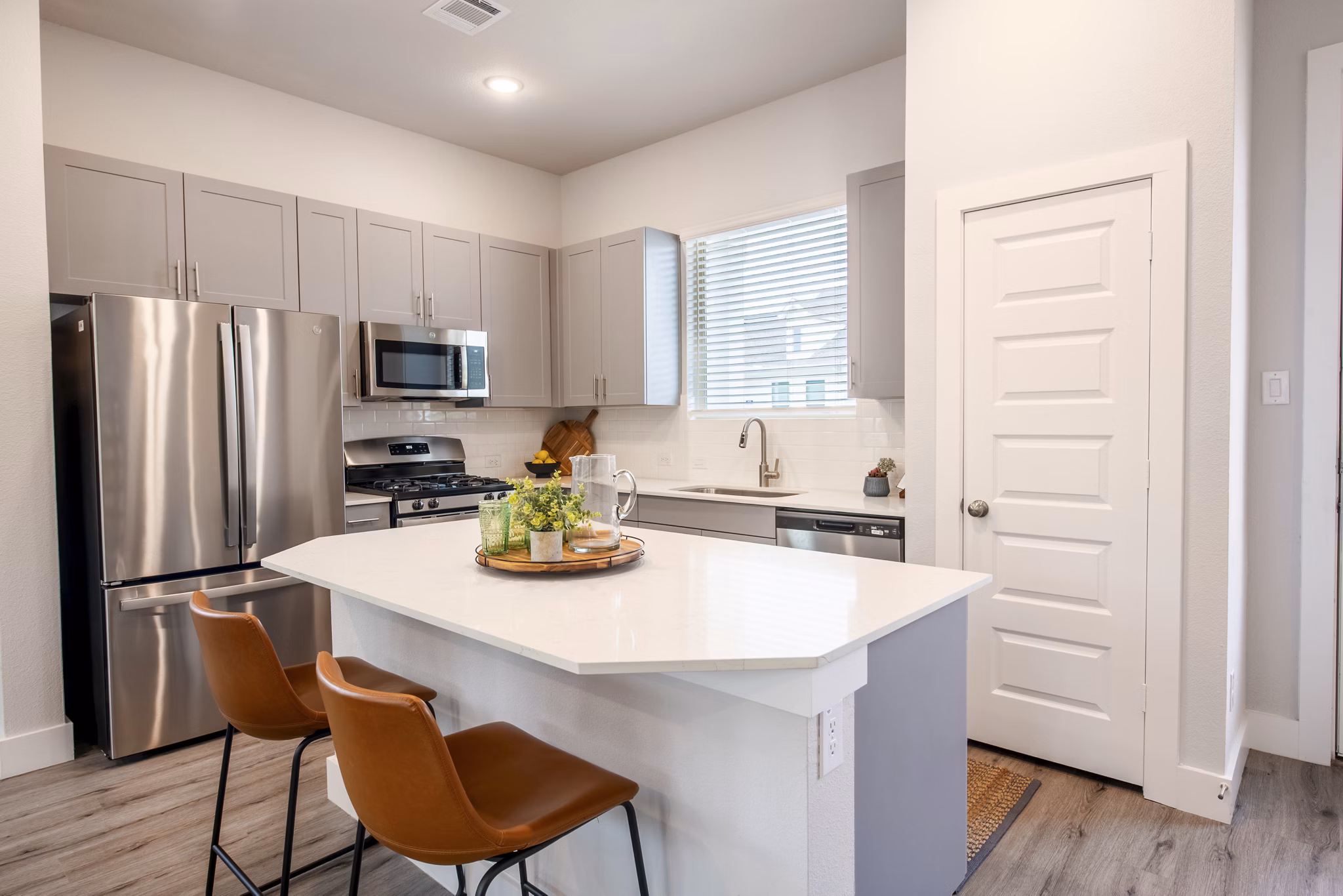 Modern kitchen with stainless steel appliances at Mission at Johnson Creek Apartments