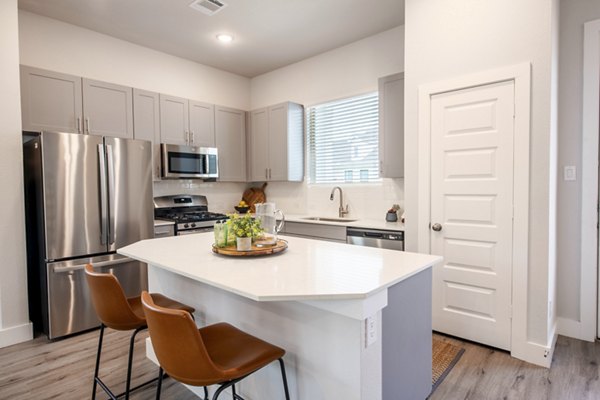 Modern kitchen with stainless steel appliances at Mission at Johnson Creek Apartments
