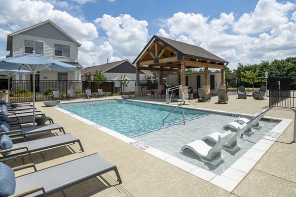 Luxurious pool with surrounding lounge chairs at Mission at Johnson Creek Apartments