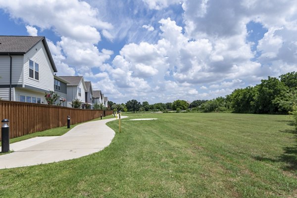 Peaceful courtyard with landscaped gardens at Mission at Johnson Creek Apartments, ideal for relaxation and community gatherings