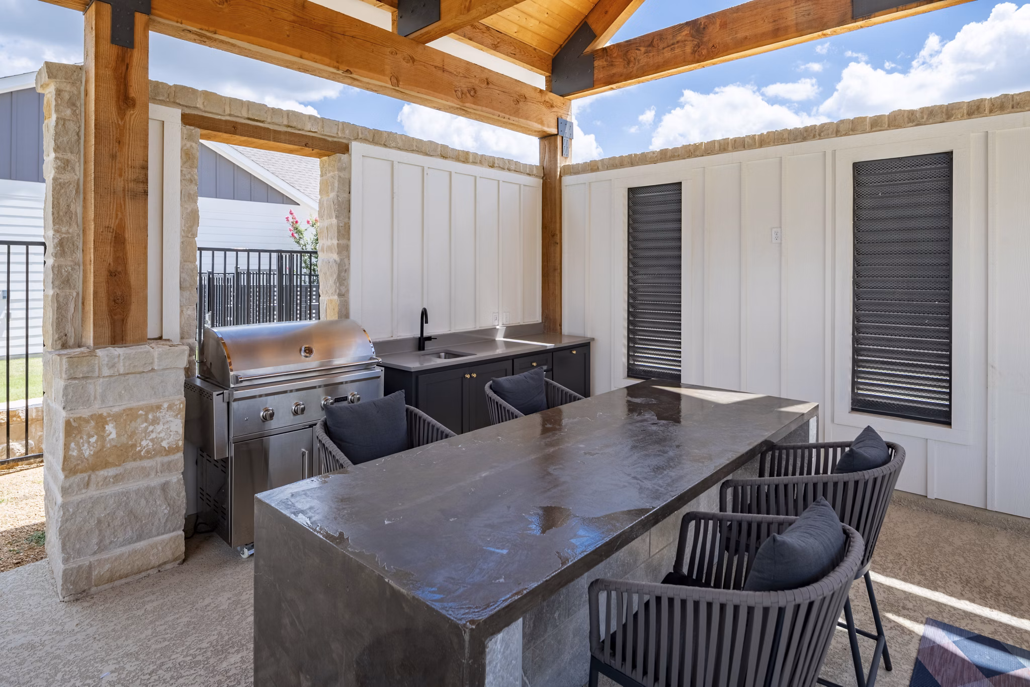 Outdoor grill area with modern seating at Mission at Johnson Creek Apartments, ideal for social gatherings and entertainment