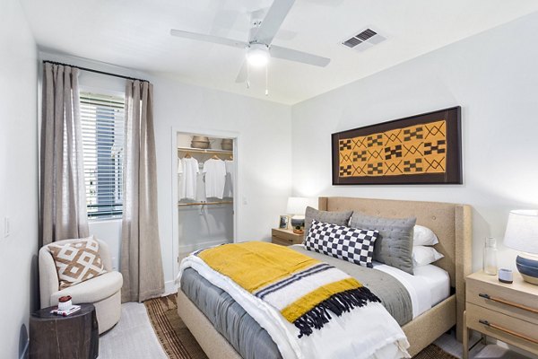 Bedroom featuring modern decor and ample natural light at Broadstone Uptown Apartments