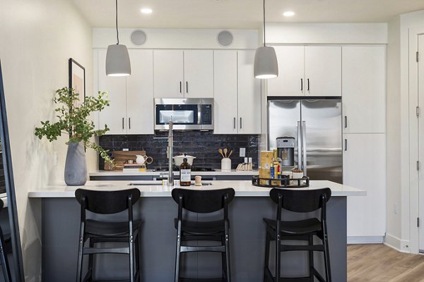 Modern kitchen featuring stainless steel appliances and granite countertops in Broadstone Uptown Apartments