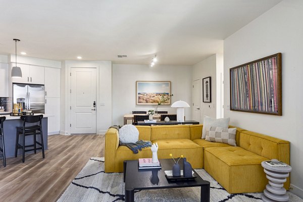 Spacious living room with modern furnishings at Broadstone Uptown Apartments, showcasing luxury comfort and style