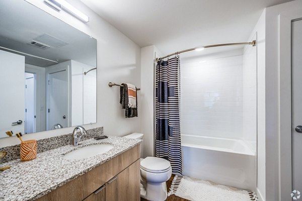 Bathroom featuring modern fixtures and marble countertops in Lariat Apartments