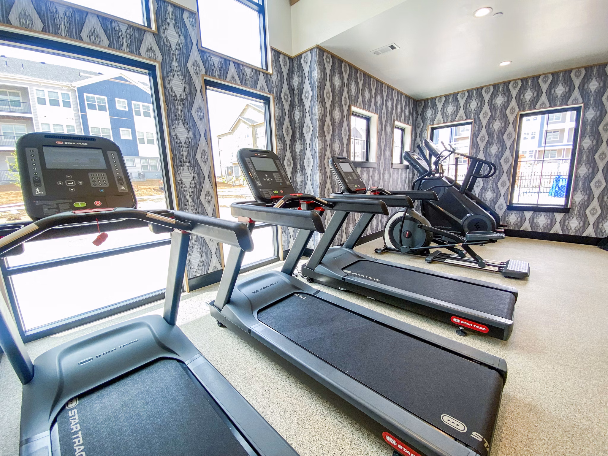 Fitness center with modern equipment at Lariat Apartments