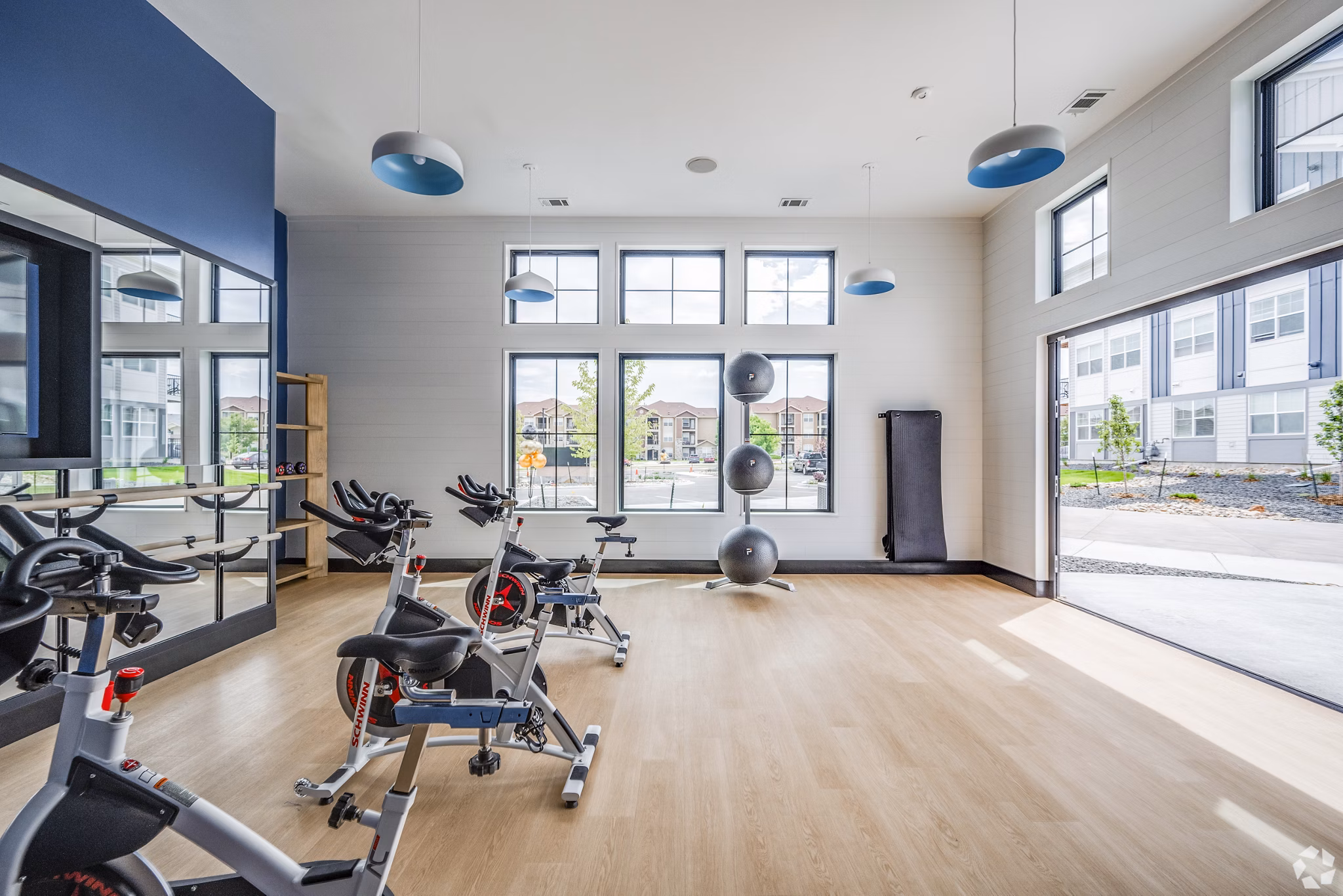 Yoga and spin studio with modern equipment at Lariat Apartments, offering wellness amenities for active lifestyles