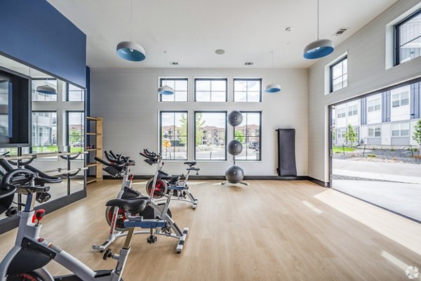 Yoga and spin studio with modern equipment at Lariat Apartments, offering wellness amenities for active lifestyles