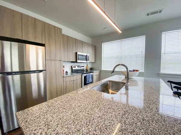 Modern kitchen with stainless steel appliances in Lariat Apartments, luxury living by Greystar