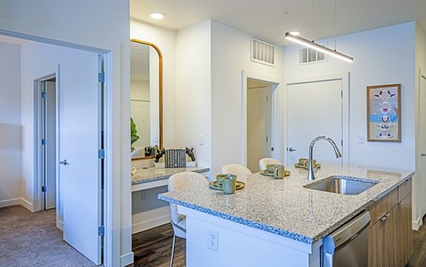 Modern kitchen with stainless steel appliances at Lariat Apartments, a luxury Greystar community