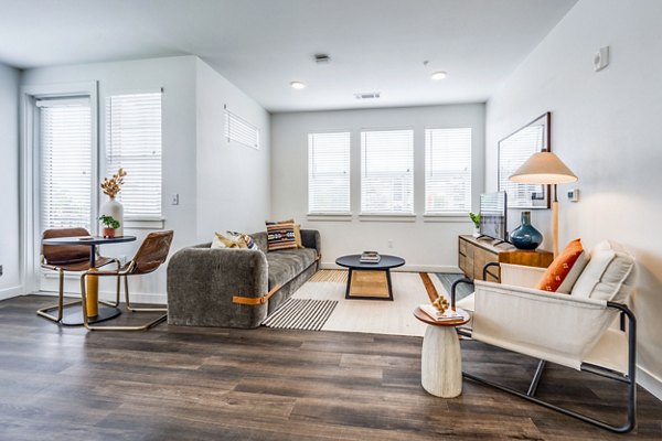 Open living and dining area with modern furnishings at Lariat Apartments
