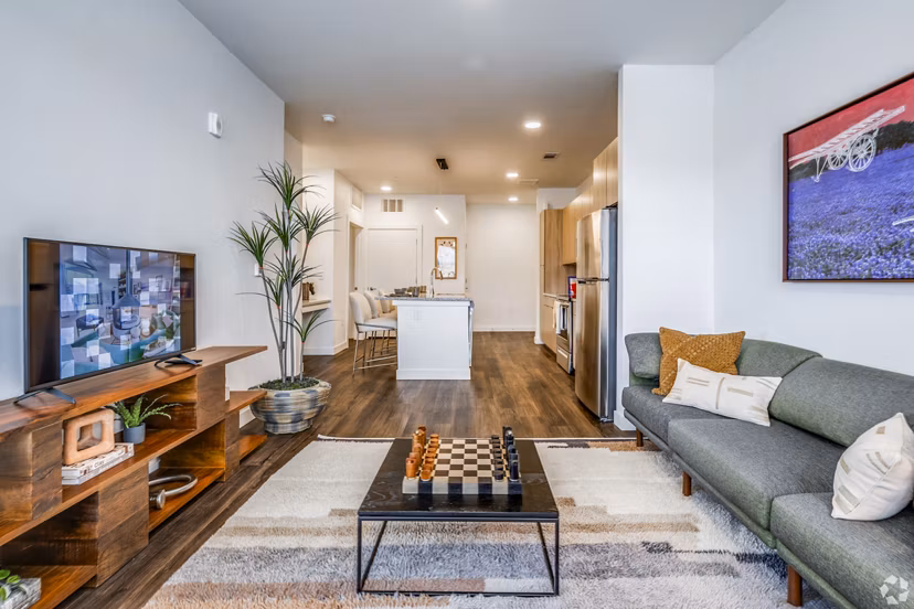 Spacious living room with modern decor at Lariat Apartments, by Greystar, featuring sleek furnishings and natural light