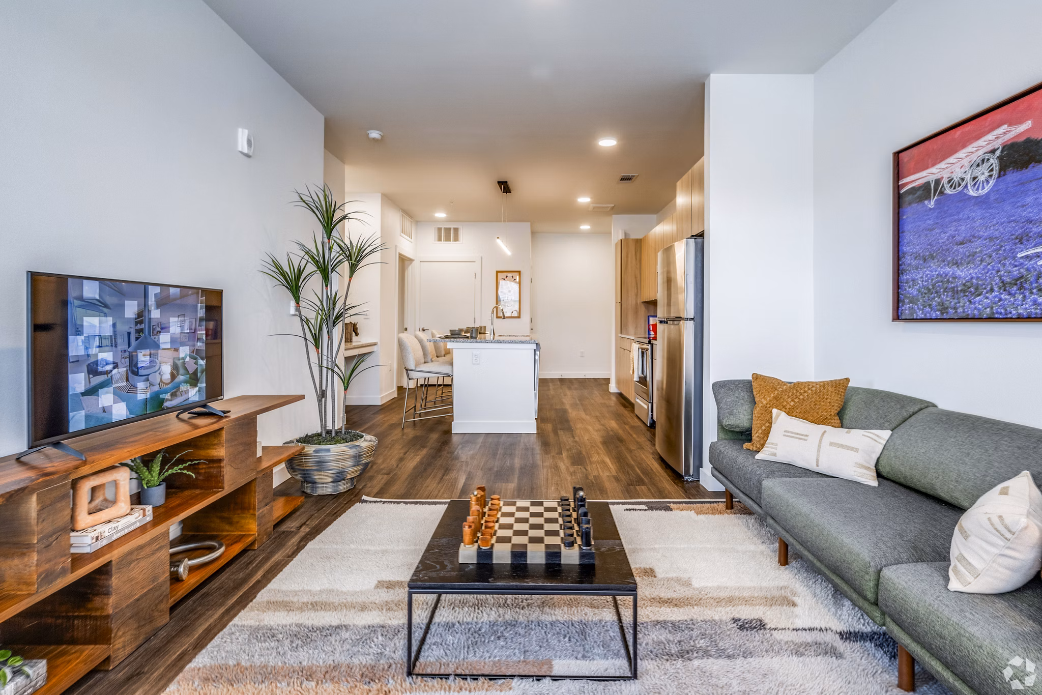 Spacious living room with modern decor at Lariat Apartments, by Greystar, featuring sleek furnishings and natural light