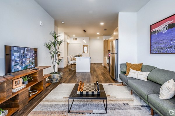 Spacious living room with modern decor at Lariat Apartments, by Greystar, featuring sleek furnishings and natural light