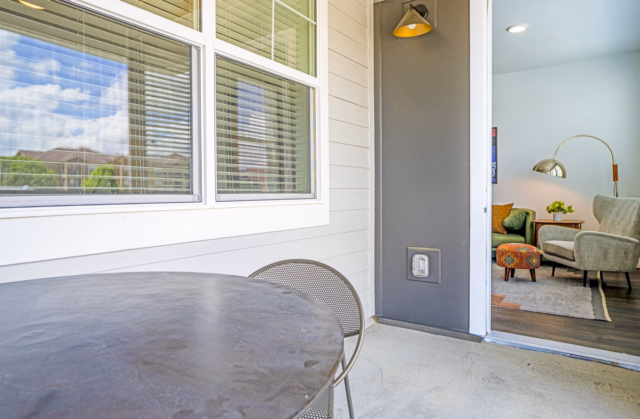 Lariat Apartments: Cozy patio/balcony with modern seating and lush foliage