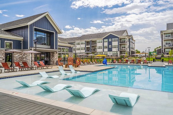Resort-style pool with lounge chairs at Lariat Apartments in Greystar community