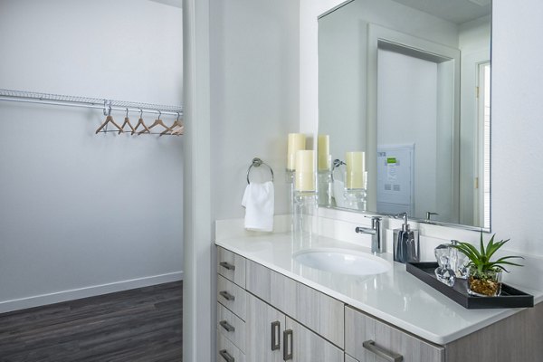 Modern bathroom featuring sleek fixtures and ample lighting at Railway Flats Apartments