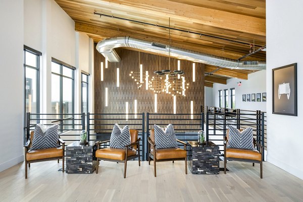 Stylish clubhouse with modern seating and entertainment areas at Railway Flats Apartments