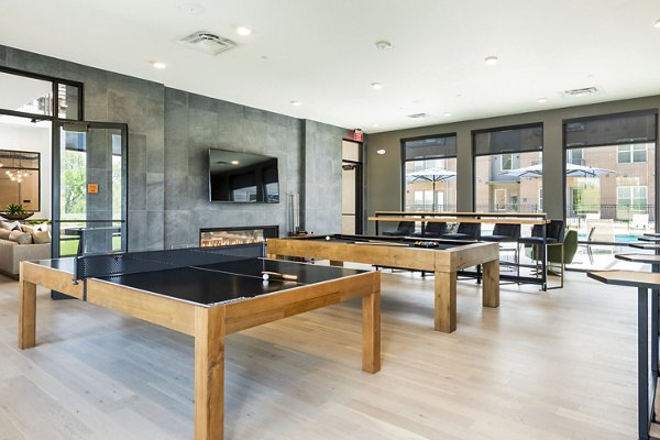 Clubhouse game room featuring pool tables and modern seating at Railway Flats Apartments