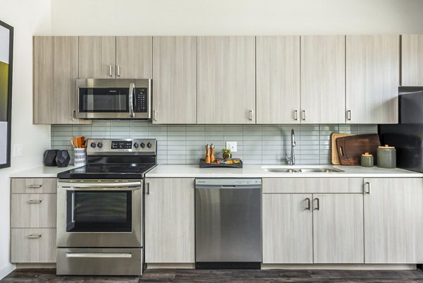 Modern kitchen featuring stainless steel appliances in Railway Flats Apartments