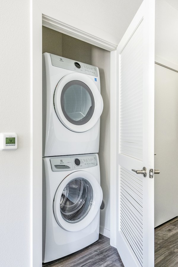 Modern laundry room with energy-efficient washers at Railway Flats Apartments