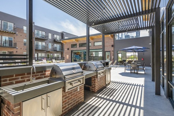 Grill patio area with modern seating at Railway Flats Apartments, ideal for outdoor gatherings