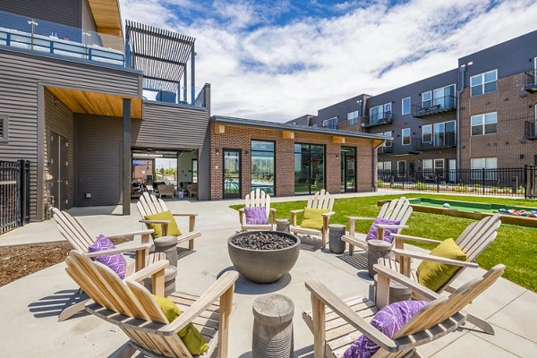 Cozy fire pit on a stylish patio at Railway Flats Apartments, perfect for evening gatherings in a serene setting