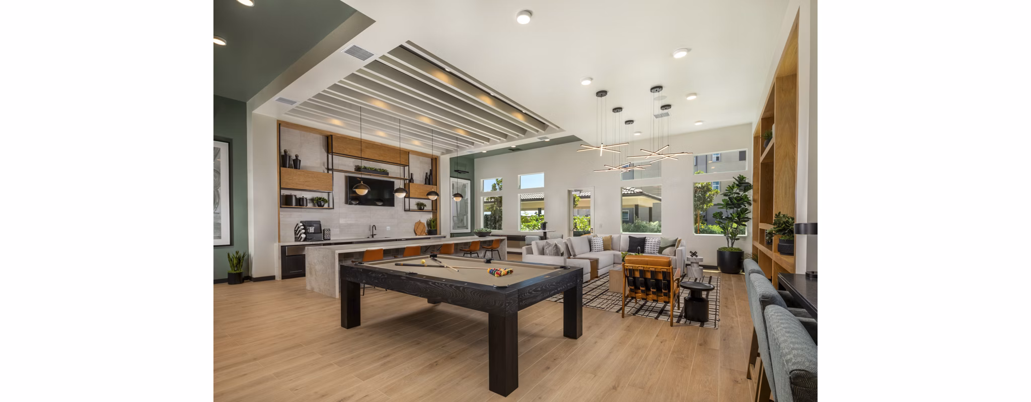 Clubhouse game room at Delhaven Pointe Apartments featuring pool table and lounge seating