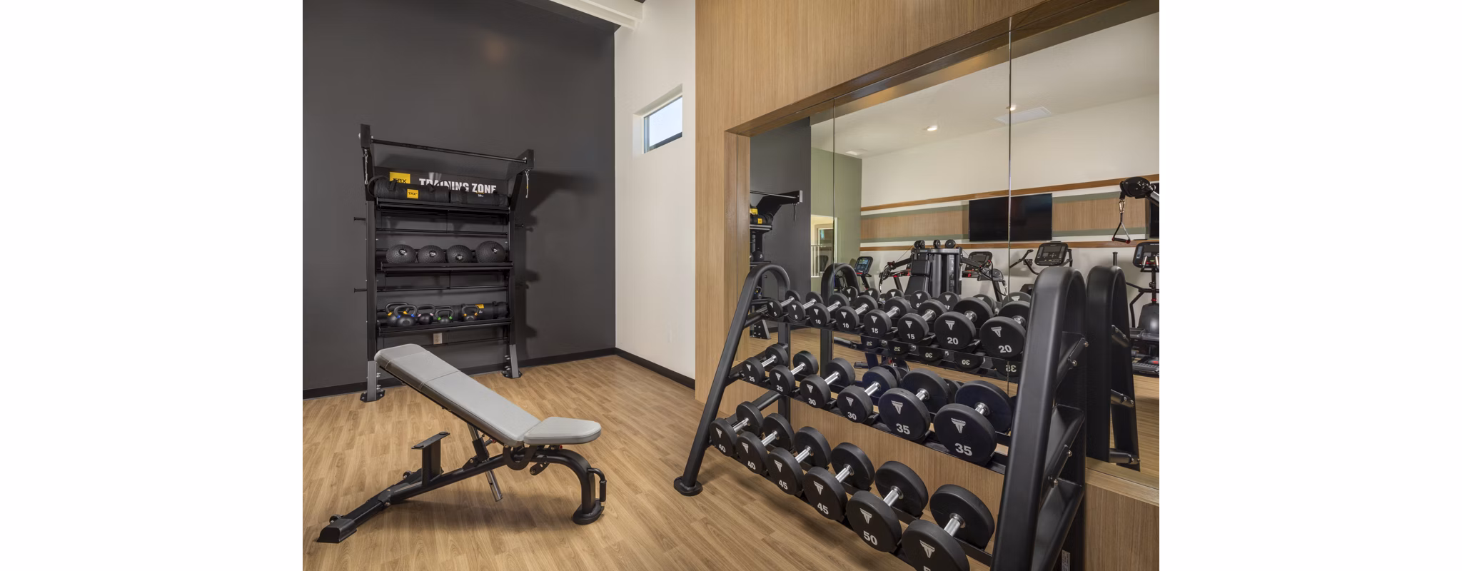 Modern fitness center at Delhaven Pointe Apartments featuring state-of-the-art equipment and spacious workout area for residents