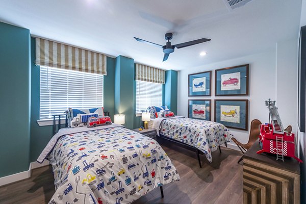 Spacious bedroom with modern decor and natural light at Eden at Sunterra Apartments