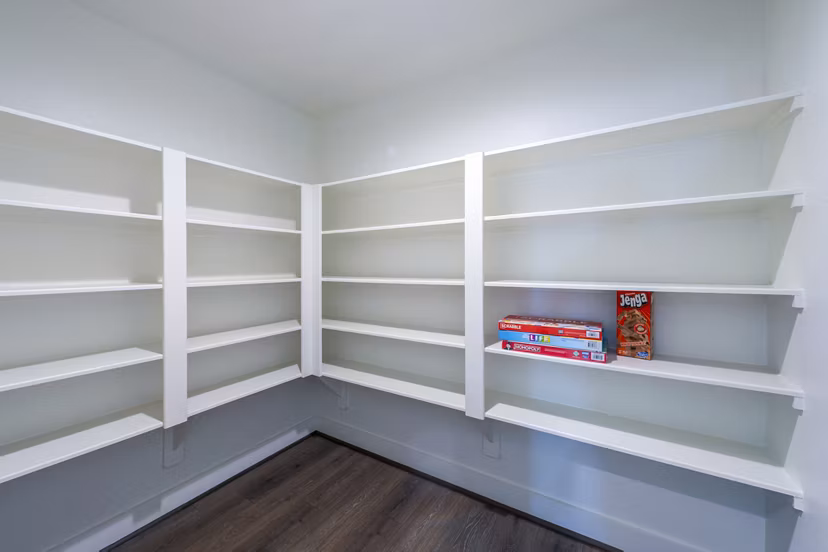 Spacious bedroom closet with open shelving in Eden at Sunterra Apartments, ideal for organized living in luxury surroundings