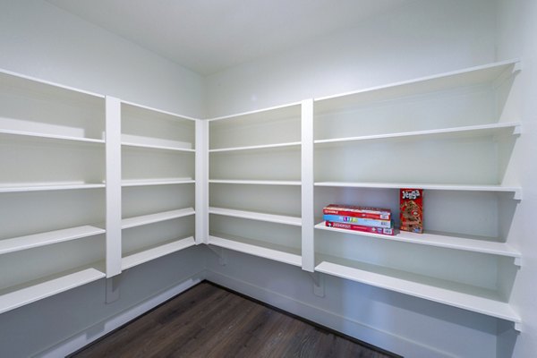 Spacious bedroom closet with open shelving in Eden at Sunterra Apartments, ideal for organized living in luxury surroundings