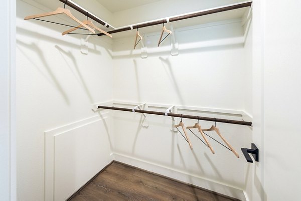 Spacious bedroom closet with personalized storage solutions in Eden at Sunterra Apartments