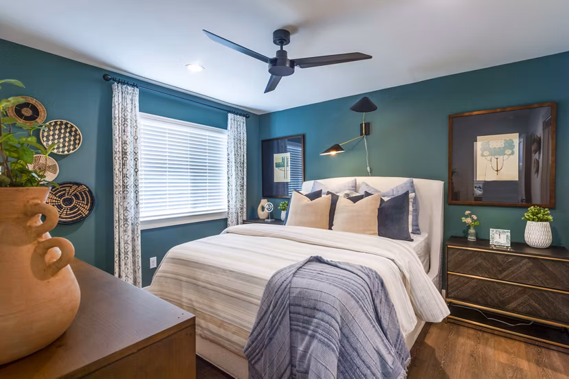 Cozy bedroom with modern decor at Eden at Sunterra Apartments, luxury living with premium amenities