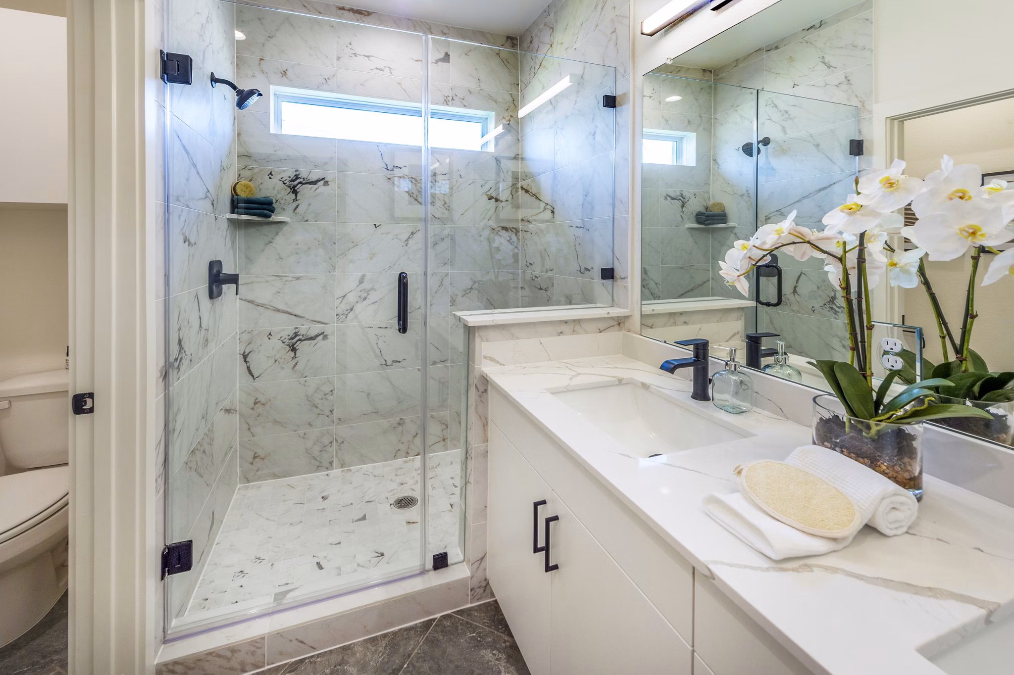 Modern bathroom featuring sleek fixtures and spacious layout at Eden at Sunterra Apartments in Texas