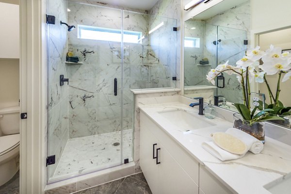 Modern bathroom featuring sleek fixtures and spacious layout at Eden at Sunterra Apartments in Texas