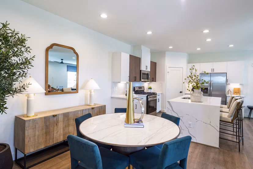 Dining room with modern furniture and pendant lighting at Eden at Sunterra Apartments, luxury living space ideal for entertaining guests