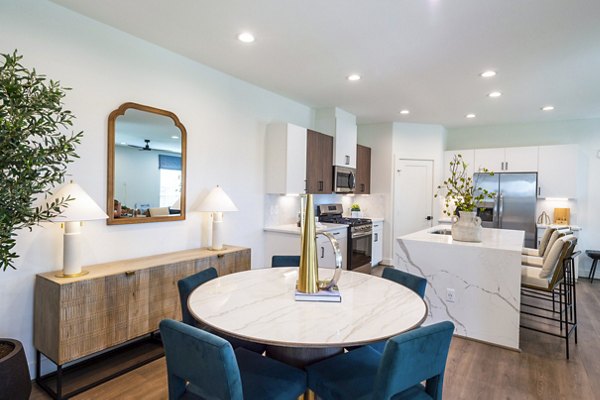 Dining room with modern furniture and pendant lighting at Eden at Sunterra Apartments, luxury living space ideal for entertaining guests