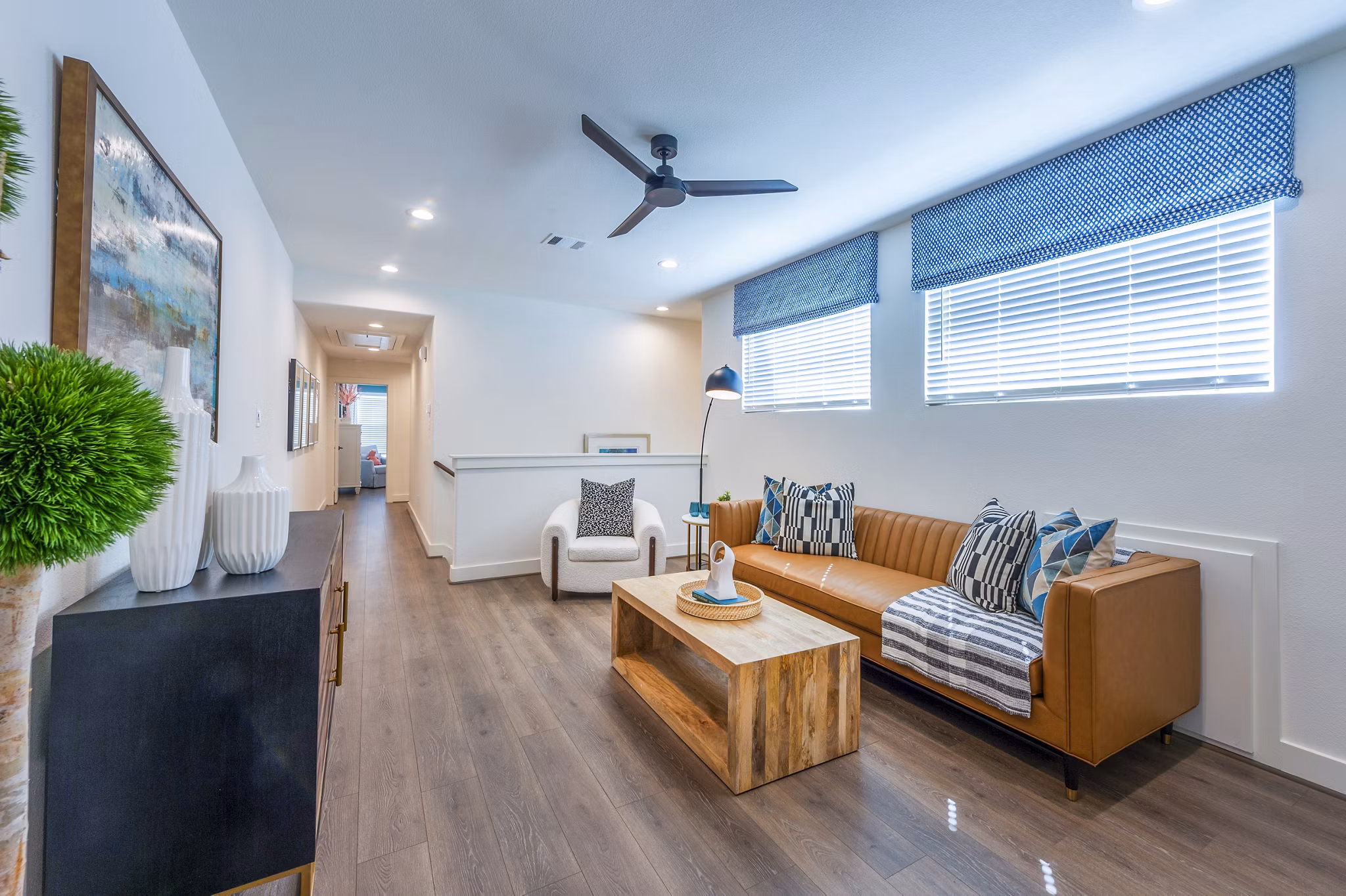 Modern living room with chic decor and large windows at Eden at Sunterra Apartments, ideal for luxury living and relaxation