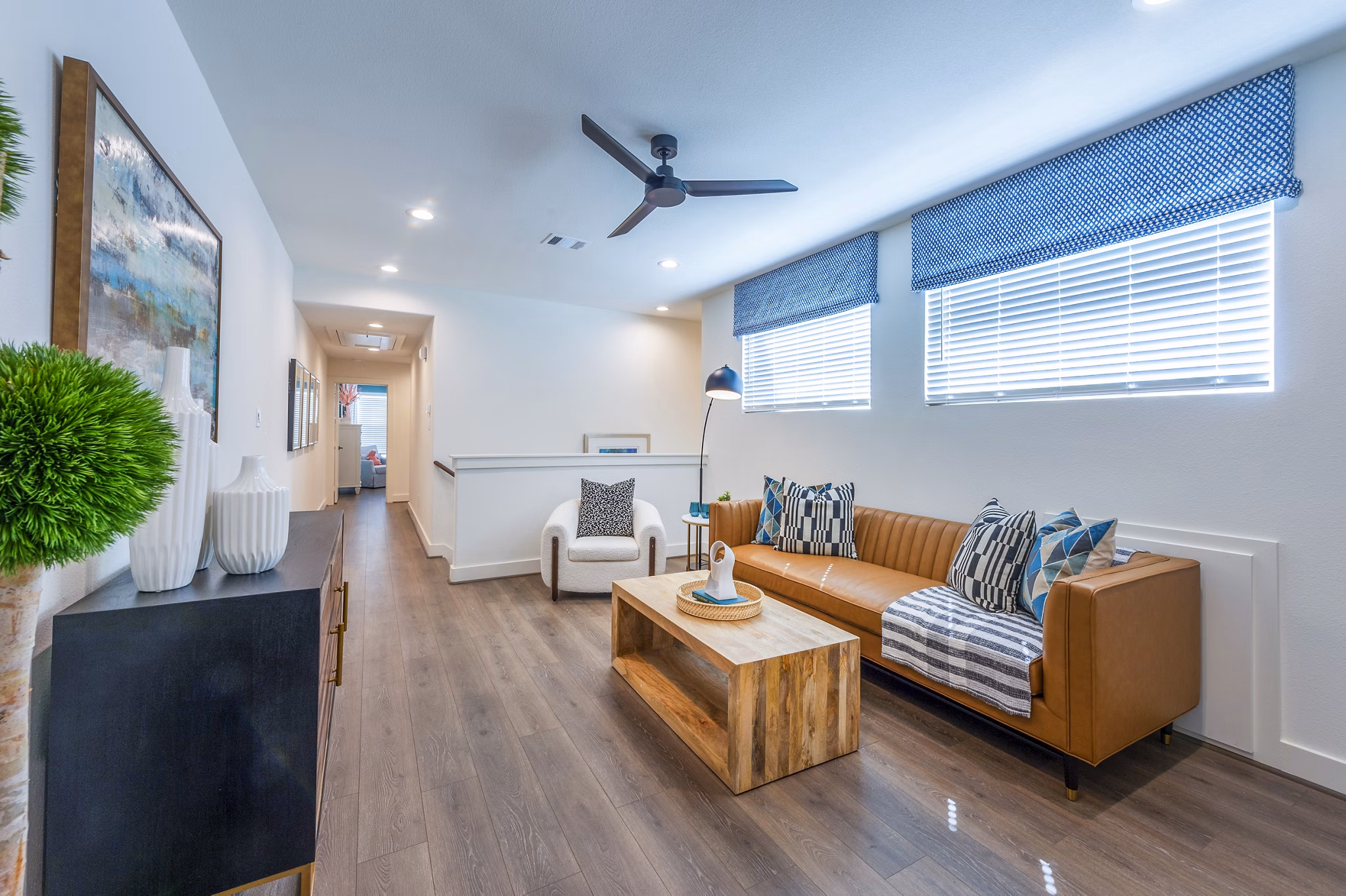 Modern living room with chic decor and large windows at Eden at Sunterra Apartments, ideal for luxury living and relaxation