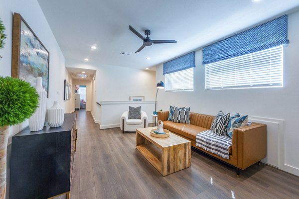 Modern living room with chic decor and large windows at Eden at Sunterra Apartments, ideal for luxury living and relaxation