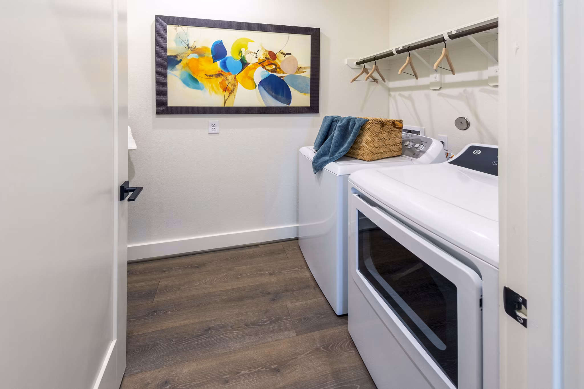 Laundry room featuring modern washers and dryers at Eden at Sunterra Apartments