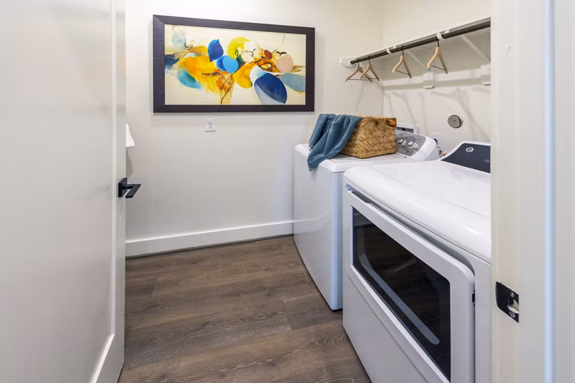 Laundry room featuring modern washers and dryers at Eden at Sunterra Apartments