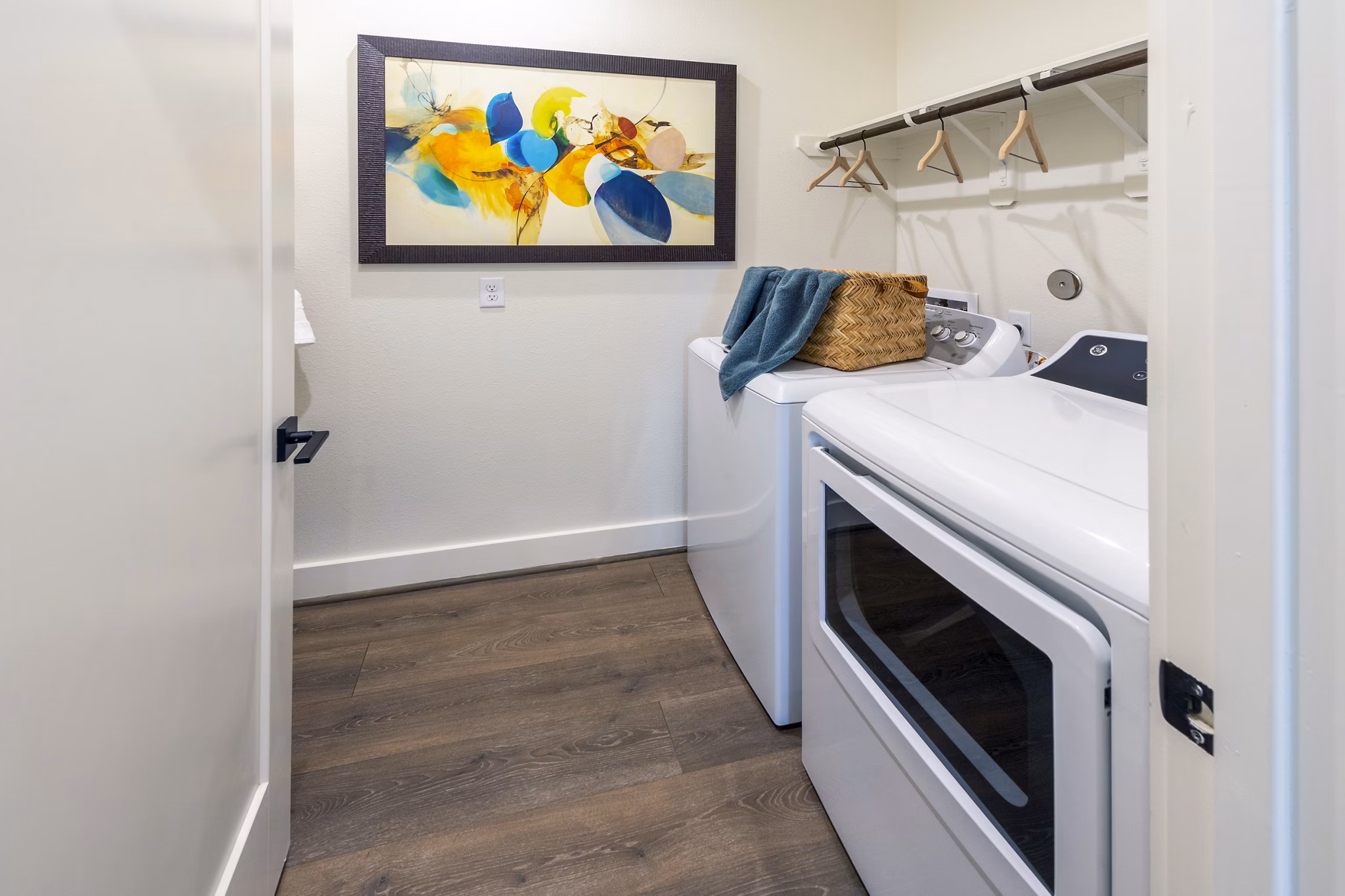 Laundry room featuring modern washers and dryers at Eden at Sunterra Apartments
