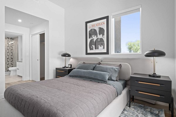 The Monde Scottsdale Apartments: Elegant bedroom with chic decor and natural light